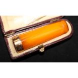 An amber cigarette holder in case.