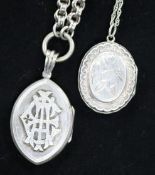 Two silver lockets on chains.