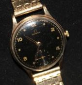 A gentleman's 1940's 9ct gold Omega wrist manual wind watch, with black Arabic dial on rolled gold