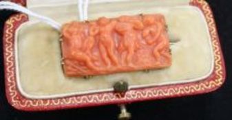 An 18ct gold mounted carved coral brooch, in fitted gilt tooled red leather box, 1.25in.