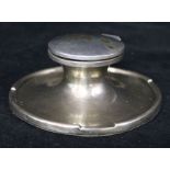 A silver capstan inkwell.