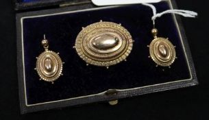A Victorian 9ct gold oval brooch and matching pair of earring in fitted box.