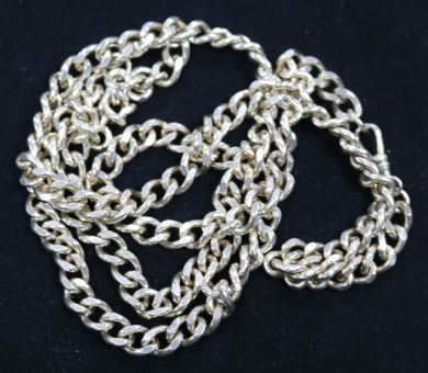 A silver curb link bracelet and necklace.