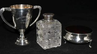 An Edwardian silver and tortoiseshell trinket box, a silver top bottle and a small silver trophy