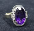 A 14k gold, amethyst and diamond set oval dress ring, size M.