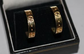 A pair of Italian Gucci 18ct gold half hoop earrings.