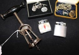 A corkscrew, two lighters, three rings and a watch chain.