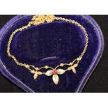 An Edwardian 15ct gold, ruby, seed pearl and enamel pendant necklace, of foliate design, 16in.