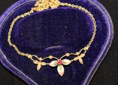 An Edwardian 15ct gold, ruby, seed pearl and enamel pendant necklace, of foliate design, 16in.