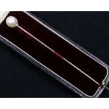 A cultured pearl set stick pin, in Goldsmiths & Silversmiths box.