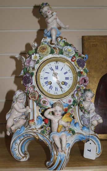 A late 19th century Thuringian porcelain mantel clock, encrusted with flowers, mounted with