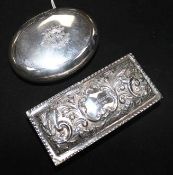 An Edwardian oval silver tobacco box and an embossed silver rectangular box.