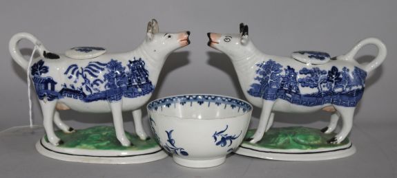 A pair of Staffordshire Willow pattern cow creamers and a Worcester blue and white tea bowl