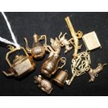 Eleven assorted 9ct gold charms.