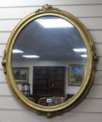 A pair of Victorian oval gilt-framed wall mirrors, H.85cm