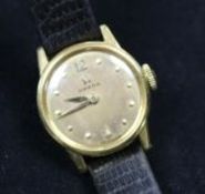 A lady's 1950's 18ct gold Omega manual wind wrist watch.