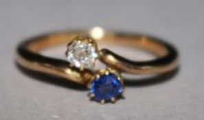 A gold sapphire and diamond crossover ring, size L.