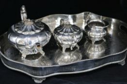A three piece plated tea set and a shaped oval gallery tray.