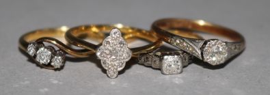 Four assorted 18ct gold and diamond set dress rings.