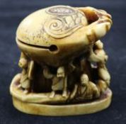 A carved ivory of figures under a crab