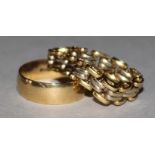 An 18ct gold wedding band and a flexible gate-link ring.