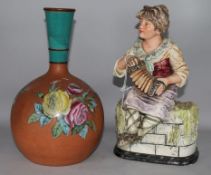 A painted pottery vase and a pottery girl