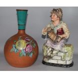 A painted pottery vase and a pottery girl