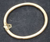 An early 20th century 15ct gold plain hinged bangle.