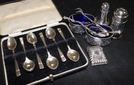 A pair of silver salts, a silver vesta, 2 silver peppers and silver spoons in case and tongs.