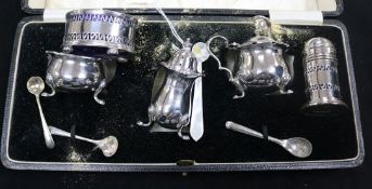 A cased silver cruet set, two other silver cruets and four condiment spoons (3 plated).