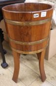 A staved and coopered teak jardiniere stand, W.70cm