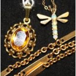 A 9ct gold and opal dragonfly pendant on chain, a 14ct gold and citrine pendant and a yellow metal