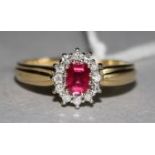 An 18ct gold, ruby and diamond cluster ring, size M.