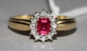 An 18ct gold, ruby and diamond cluster ring, size M.