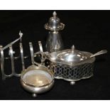 A George V silver lidded mustard pot, pepper pot and toastrack and a plated salt.