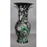 A Chinese famille noir long-necked baluster vase on stand