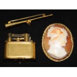 A 15ct gold hunting horn brooch, a cameo brooch and a Dunhill lighter.