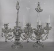A pair of glass and lustre drop candelabra (converted to electricity)