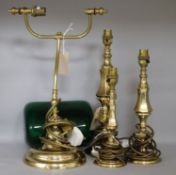 A modern brass table lamp, a similar pair of table lamps (all with shades) and a brass student's