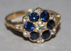 A gold, sapphire and diamond cluster ring, size M.