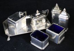 Six 20th century silver condiments and a silver stand.