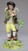 An early 19th century pearlware figure of a shepherd carrying a lamb (chip to front of hat)
