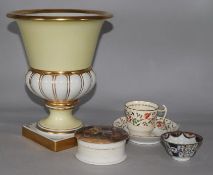 A Portuguese vase, a Rockingham cup and saucer, a tea bowl and saucer and a pot lid and base "A