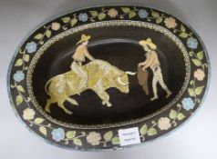 A Spanish faience oval dish decorated with bull fighting scene