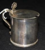 A George III silver drum shaped mustard pot, with pierced anthemion thumbpiece