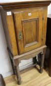 An 18th century French oak cupboard on a later stand, H.129cm