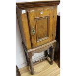 An 18th century French oak cupboard on a later stand, H.129cm