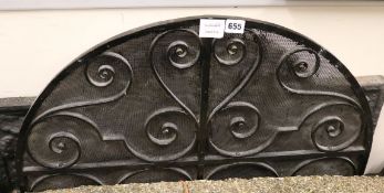 A 16th century style black painted cast iron fire back and a wrought iron spark guard fire back W.
