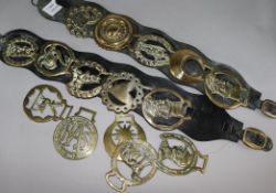 A small collection of horse brasses and two martingale straps