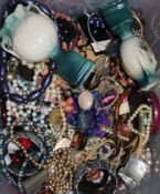 A large quantity of costume jewellery in two containers.